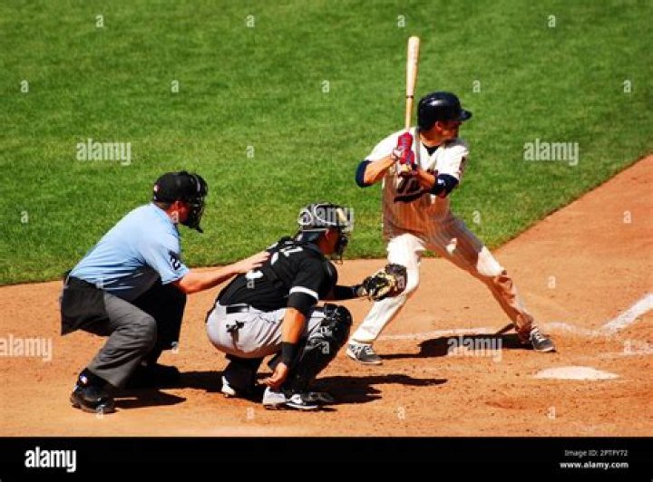 A batter at the plate, with a catcher and umpire behind him, as a pitcher winds up in Super Mega Baseball 3