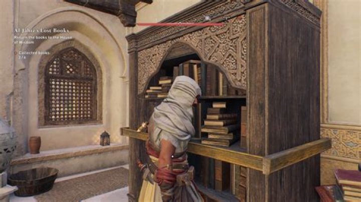 Basim moves a bookshelf to find a Gear Chest in the top floor of a building in AC Mirage.