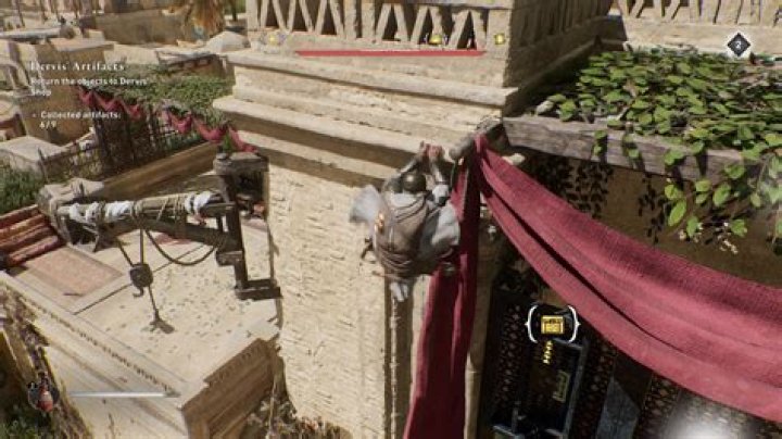 Basim scales a building while getting a Gear Chest location in AC Mirage.
