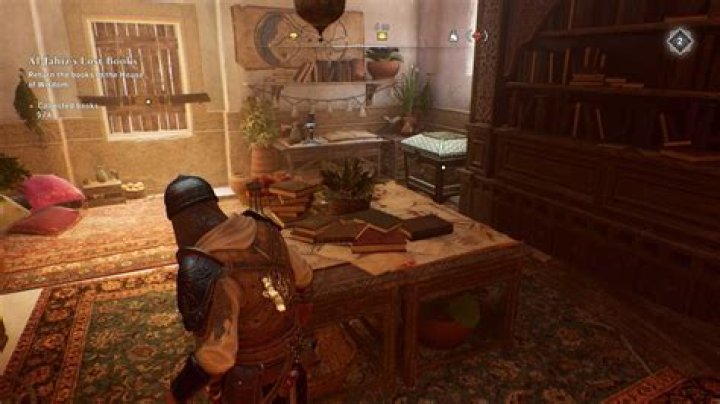 Basim walks toward a table in a room with a Gear Chest location in it in AC Mirage.