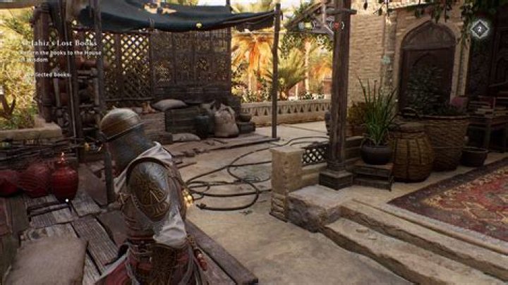 Basim walks toward an explosive jar while looking for Gear Chest locations in AC Mirage.