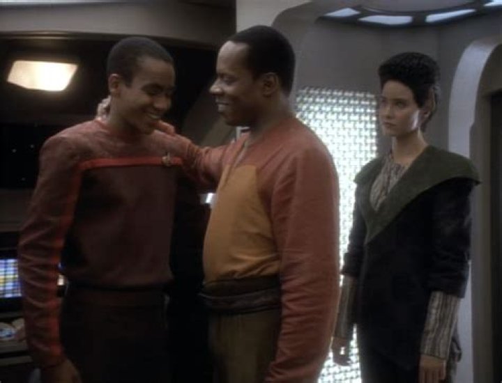 Commander Sisko smiling at his son Jake in an episode of Deep Space Nine
