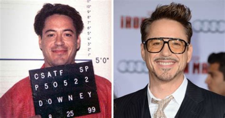Robert Downey Jr. holds out his hand wearing an Iron Man arm in Iron Man
